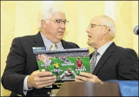  ??  ?? Outgoing Cobb Chairman Tim Lee (left) received a sports book from Charlie Crowder after his speech at the Kiwanis Club of Marietta at the Hilton Marietta Hotel & Conference Center.