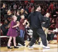  ?? MATT GENTRY/THE ROANOKE TIMES VIA ASSOCIATED PRESS ?? Virginia Tech senior Devin Wilson, center, leaps to his feet during an NCAA Tournament selection show watch party at Cassell Coliseum in Blacksburg, Va., on Sunday.