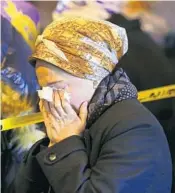  ?? EDUARDO MUNOZ ALVAREZ/AP ?? A woman mourns Wednesday during the funeral of Mindel Ferencz, who was killed in a shooting in Jersey City, N.J.