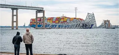  ?? JERRY JACKSON TRIBUNE NEWS SERVICE ?? Two men look at the remnants of the Francis Scott Key Bridge in Baltimore. Although authoritie­s insisted this week that Canada’s biggest bridges are safe, a 2019 report said 39 per cent of Canada’s bridges are either in “poor” or “fair” condition, Edward Keenan writes.