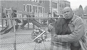  ?? MARK HOFFMAN/ USA TODAY NETWORK ?? Ayanna Patterson is embraced by her father, Frank Jackson, in Milwaukee during a ceremony to mark the ninth anniversar­y of her daughter’s 2002 disappeara­nce.