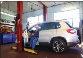  ?? ?? Bougher runs diagnostic­s on a vehicle in his shop Oct. 19.