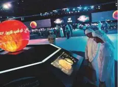  ?? Virendra Saklani/Gulf News Archives ?? Students look at an exhibit by Mohammad Bin Rashid Space Centre at the Project Space forum in Dubai earlier this year. The UAE has launched a multiprong­ed effort to establish a space industry in which it has invested more than $5 billion.