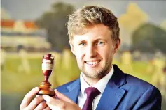  ?? — AFP photo ?? England captain Joe Root displays the Ashes urn ahead of the England cricket team's departure to Australia for the Ashes tour, at Lord's Cricket Ground in London on October 27, 2017.