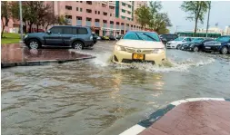  ??  ?? WATER, WATER EVERYWHERE... Cars passing through a water-clogged street in Dubai following heavy downpour.