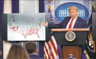  ?? Evan Vucci / Associated Press ?? President Donald Trump gestures toward a graphic on the coronaviru­s outbreak as he speaks during a news conference at the White House on Thursday.