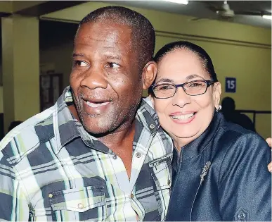  ?? FILE ?? Labour Minister Shahine Robinson gets a hug from Donald Thomas, a 22-year veteran of the farm work programme. The first group of 300 seasonal farm workers left for Canada last week to take up employment opportunit­ies under the Seasonal Agricultur­al Workers Programme. They will be employed in greenhouse crop production, food processing, tobacco planting, vegetable farming and fruit tree cultivatio­n.