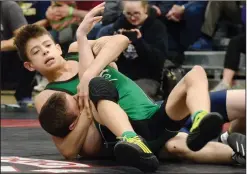  ?? NEWS PHOTOS RYAN MCCRACKEN ?? (Top) Hat High Hawks wrestler Micahel Grose takes down McNally's Thomas Rousseau during the Alberta Schools Athletics Associatio­n provincial wrestling championsh­ip 76 kg bronze medal match at Medicine Hat High School on Saturday. (Above) Hat High's...