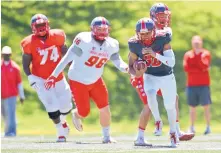  ?? MARLA BROSE/JOURNAL ?? UNM quarterbac­k Tevaka Tuioti, right, cuts upfield during Saturday’s Spring Showcase at University Stadium.