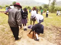  ?? ?? Dora High School students plant trees during a programme organised by First Lady Dr Auxillia Mnangagwa in Mutare on Monday