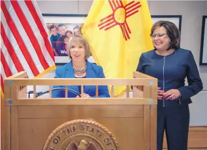  ?? EDDIE MOORE/JOURNAL ?? Gov.-elect Michelle Lujan Grisham, left, and Gov. Susana Martinez hold a news conference in the state Capitol after meeting in the Governor’s Office on Friday. The two declined to answer questions about political difference­s.
