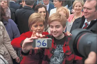  ??  ?? TRIUMPHANT: First Minister Nicola Sturgeon in jubilant mood at a photocall for the 56 SNP MPs in South Queensferr­y shortly after the party’s near clean sweep north of the Border in the General Election in May.