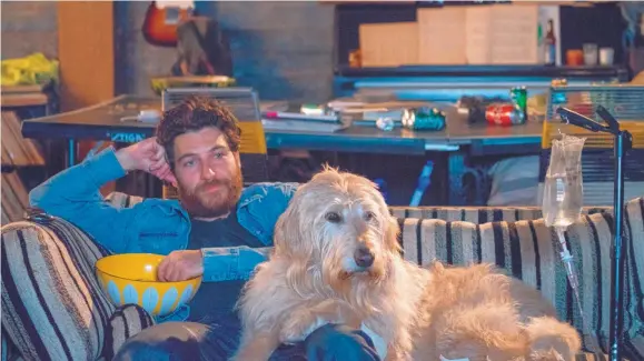  ?? COURTESY OF JACOB YAKOB/ LD ENTERTAINM­ENT ?? Adam Pally stars as Dax with Charlie the dog in Ken Marino’s “Dog Days.”