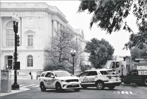  ?? AP PHOTO/J. SCOTT APPLEWHITE ?? Police vehicles and heavy trucks block access to Supreme Court Building in Washington, on Wednesday as security measure are enhanced on the perimeter following protests sparked by news that the court might overturn cases that guarantee abortions.