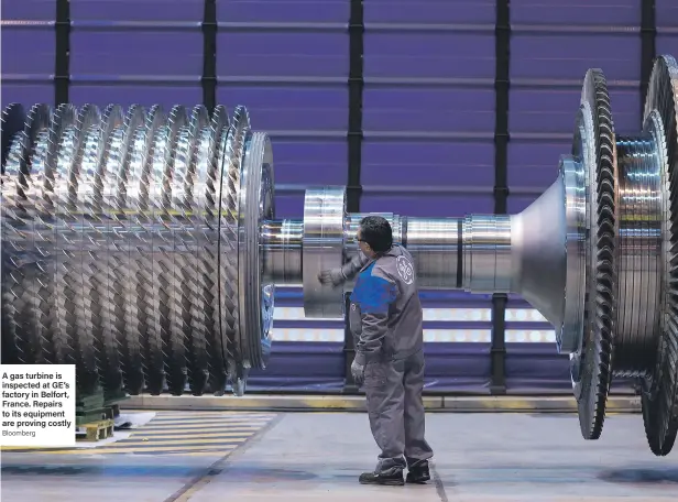  ??  ?? A gas turbine is inspected at GE’s factory in Belfort, France. Repairs to its equipment are proving costly