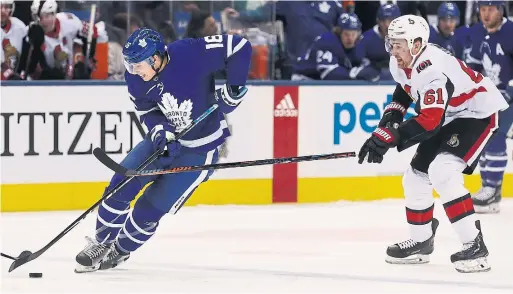  ?? RICHARD LAUTENS TORONTO STAR ?? Mitch Marner, beating Mark Stone of the Senators, picked up a pair of assists in Wednesday night’s Leaf win. The pace of Marner’s contract talks was a hot topic.