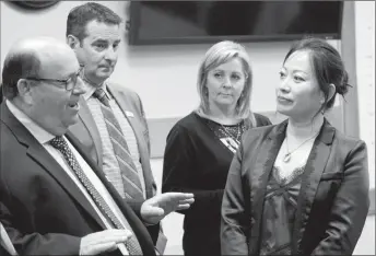  ?? Herald photo by Greg Bobinec ?? Lethbridge County Reeve Lorne Hickey discusses southern Alberta agricultur­e production and products with Consul General of China, Lu Xu, at the Lethbridge County office Thursday afternoon.