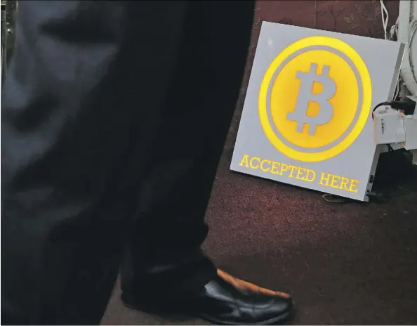  ?? KIN CHEUNG/THE ASSOCIATED PRESS ?? A man stands near a bitcoin ATM in Hong Kong. China, the biggest producer and consumer of coal, is the biggest operator of computer “mines” that produce cryptocurr­encies. Some observers are raising alarm about cryptocurr­encies’ insatiable appetite for...