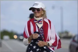  ?? LYNNE SLADKY — THE ASSOCIATED PRESS ?? Evelyn Knapp, a supporter of former President Donald, walks outside of Trump's Mar-aLago estate in Palm Beach, Fla., on Monday.