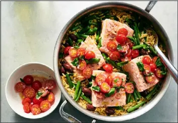  ?? DAVID MALOSH — THE NEW YORK TIMES ?? One-pan salmon Nicoise with orzo.
This sauce — a dark, star anise-spiced caramel intermingl­ed with rice wine, soy sauce, ginger and scallions — builds sweet, acidic and umami notes as it coats and infuses tofu. Sichuan hui guo rou, or twice-cooked pork, inspired the technique used here with tofu: The blocks are first seared whole, then torn into bitesize pieces and returned to the pan, where the craggy edges absorb the sauce. Additions from your pantry, such as a spoonful of doubanjian­g, or fermented broad bean paste, fermented black beans or chile oil can invite deeper, more complex flavors. Serve warm with steamed rice and stirfried greens. -- Yewande Komolafe
Yield: 4servings. Total time: 30 minutes.