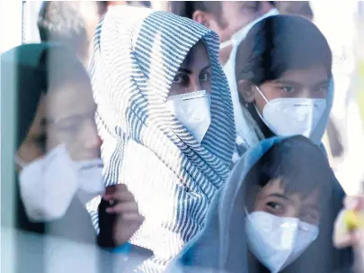  ?? MATTHIAS SCHRADER/AP ?? Recently evacuated young Afghan girls sit in a tent at the Ramstein U.S. Air Base in Germany on Tuesday. The largest American military community overseas housed thousands of Afghan evacuees in an increasing­ly crowded tent city.