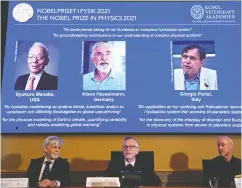  ?? JONATHAN NACKSTRAND / AFP VIA GETTY IMAGES ?? Goran K. Hansson, centre, Secretary General of the Royal Swedish Academy of Sciences, and members of the Nobel
Committee for Physics Thors Hans Hansson, left, and John Wettlaufer sit in front of a screen displaying the co-winners of the 2021 Nobel Prize in Physics: Syukuro
Manabe, Klaus Hasselmann and Giorgio Parisi.