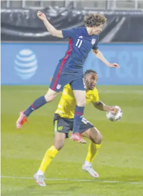  ??  ?? Jamaica defender Liam Moore and United States midfielder Aaronson Brenden (airbourne) vie for the ball.