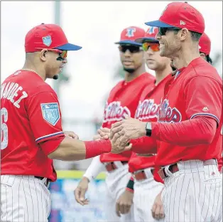  ?? AP PHOTO ?? Philadelph­ia Phillies manager Gabe Kapler, right, shakes hands with second baseman Cesar Hernandez before a baseball spring exhibition game against the Baltimore Orioles on Feb. 28 in Clearwater, Fla.