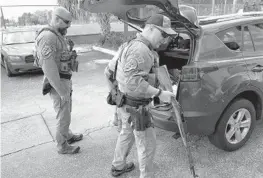  ?? WAYNE K. ROUSTAN/SUN SENTINEL ?? Hollywood police collected dozens of firearms during a gun buyback Saturday.