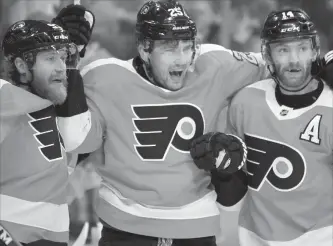  ?? TOM MIHALEK THE ASSOCIATED PRESS ?? The Philadelph­ia Flyers’ James van Riemsdyk, centre, is joined by Jakub Voracek, left, and Sean Couturier as he celebrates his goal in Tampa, Nov. 17. The Flyers face the Toronto Maple Leafs on Saturday night.