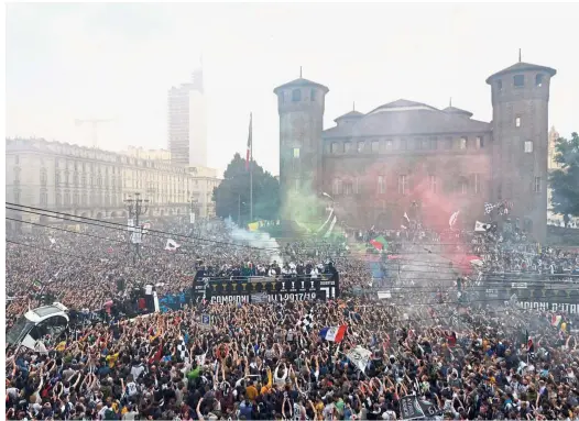  ??  ?? Party time: Juventus players celebratin­g with the fans after winning the Serie A. — Reuters