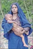  ??  ?? Noor Aishya, a Rohingya Muslim woman who crossed over from Myanmar into Bangladesh, holds her sick daughter, Kismet Ara, after receiving food aid near the Taiy Khali refugee camp.