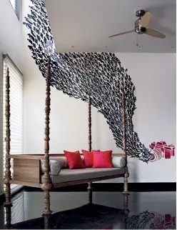  ??  ?? An artwork by Untitled Design frames the day bed in the lounge (above); while a textured wall becomes a backdrop in the living room (below)