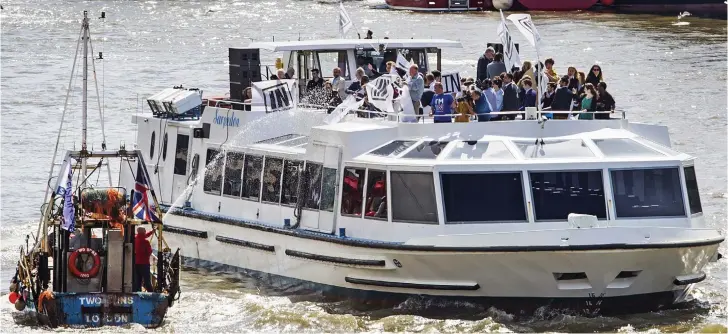  ??  ?? Battle of the Thames: Remain campaigner­s aboard Sir Bob Geldof’s 115ft river cruiser get a soaking from one of the fishing vessels protesting at the EU’s Common Fisheries Policy