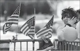  ?? ROBERT F. BUKATY/AP PHOTO ?? A woman wipes away a tear April 22, 2013, at a memorial for the victims of the Boston Marathon bombing on Boylston Street, near the race finish line in Boston.