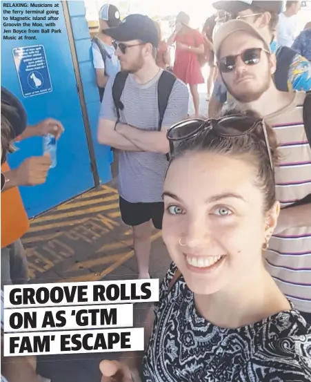 ?? RELAXING: Musicians at the ferry terminal going to Magnetic Island after Groovin the Moo, with Jen Boyce from Ball Park Music at front. ??