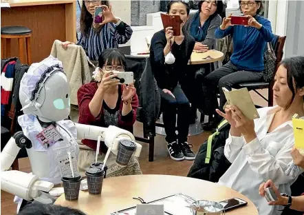  ?? WASHINGTON POST ?? A robot serves drinks at a cafe in Tokyo where avatar robots are operated by staff with severe physical disabiliti­es.