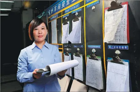  ?? LIU DAWEI / XINHUA ?? Hu Xiaoyan inspects safety production at the ceramics factory where she used to work in Foshan, Guangdong province, in 2013.