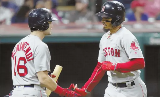  ?? Ap pHOTO ?? NOT QUITE ENOUGH: Red Sox right fielder Mookie Betts (right) gets some love from Andrew Benintendi after hitting a solo home run off Indians starter Adam Plutko in the fifth inning of last night’s game in Cleveland. The Sox fell, 4-3, in 11 innings.