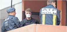  ?? FOTO: DPA ?? Polizisten und ein Feuerwehrm­ann bei der Durchsuchu­ng der Wohnung des Terrorverd­ächtigen Mitte Juni in Köln.