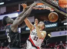  ?? Mark Mulligan / Staff photograph­er ?? Center Clint Capela, left, tried to provide the Rockets some energy, but his efforts were overshadow­ed by others’ futility.