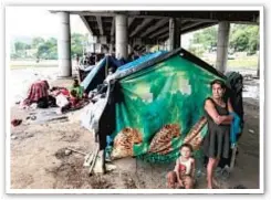  ?? AP ?? Hurricane victims take refuge in a shelter (top) and under a bridge (above) in San Pedro Sula, Honduras, in the wake of Category 4 Hurricanes Eta and Iota which devastated Central America.