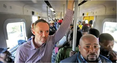  ?? PICTURE: BHEKI RADEBE/AFRICAN NEWS AGENCY/ANA ?? EYE WITNESS: In a surprise commute, the City’s Brett Herron boarded an early morning train heading from Nolungile Station in Khayelitsh­a to Cape Town.