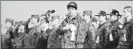  ??  ?? Japan's Defence Minister Itsunori Onodera (C) reviews self-defense troops