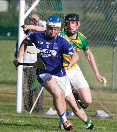  ??  ?? Milford’s Ryan O’Gorman breaks out of defence despite the attention of Ballymartl­e’s Niall Crowley during the closing stages of last weekend’s County Intermedia­te Hurling Championsh­ip clash Photo by Eric Barry