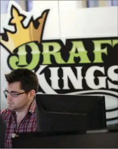  ?? AP PHOTO/CHARLES KRUPA ?? In this Jan. 11 file photo, employees work at the DraftKings office in Boston. The explosion in popularity of daily fantasy sports over the last decade has created a generation of sports fans more attuned to gauging individual player statistics than...
