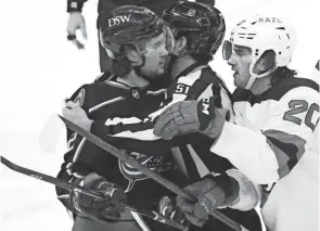  ?? ?? Columbus Blue Jackets defenseman Andrew Peeke (2) and New Jersey Devils center Michael Mcleod (20) fight during the third period of Saturday’s game at Nationwide Arena.