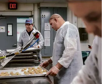  ?? PHOTOS BY CARLIN STIEHL FOR THE BOSTON GLOBE ?? Kevin Doherty (left) produced a yellow pea field fritters with his team at CommonWeal­th Kitchen in Dorchester. The team hopes to use the crop as a sustainabl­e protein source.