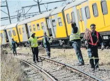  ?? Russell/ Sunday Times ?? Repeat offender: Metrorail workers during operations on the scene where two trains collided in Selby, near the Booysens train station, south of Johannesbu­rg in September 2018./Alaister
