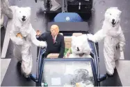  ?? BERND THISSEN/DPA ?? Demonstrat­ors costumed as President Donald Trump and polar bears protest against climate change during a climate conference in Bonn, Germany, on Saturday.